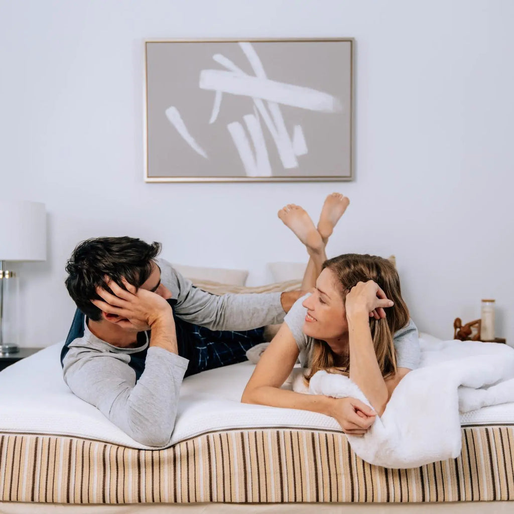 Woman and man lounging on an Essentia dormeuse REM9 Mattress