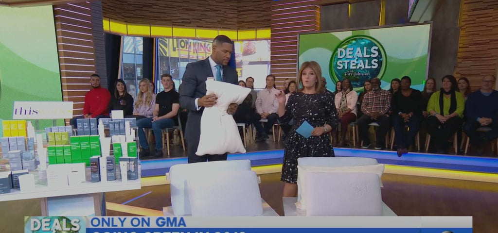 Michael Strahan holding an Essentia organic pillow on Good Morning America