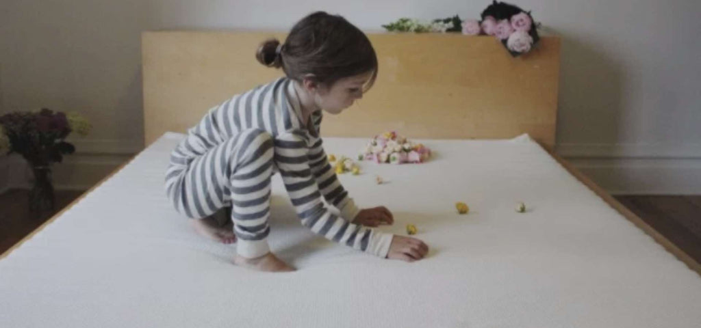 Child playing on his new organic mattress.