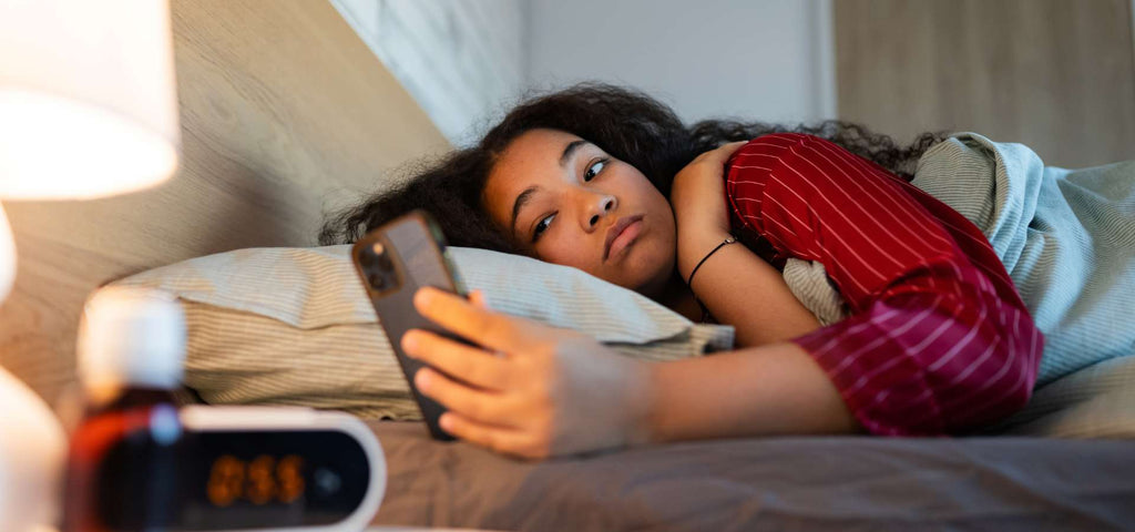 Woman struggling to sleep while being affected by the Winter Blues