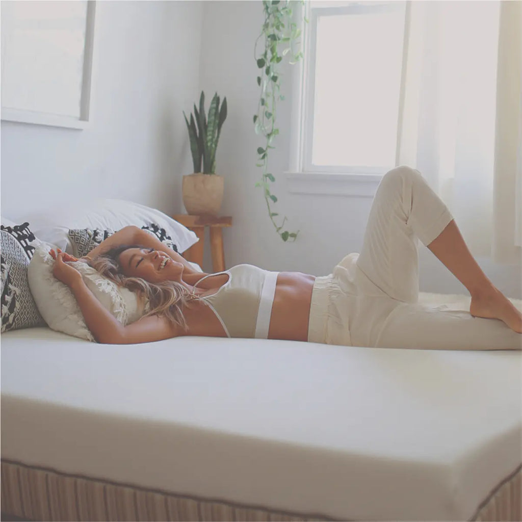 A young influencer lying on a Essentia mattress