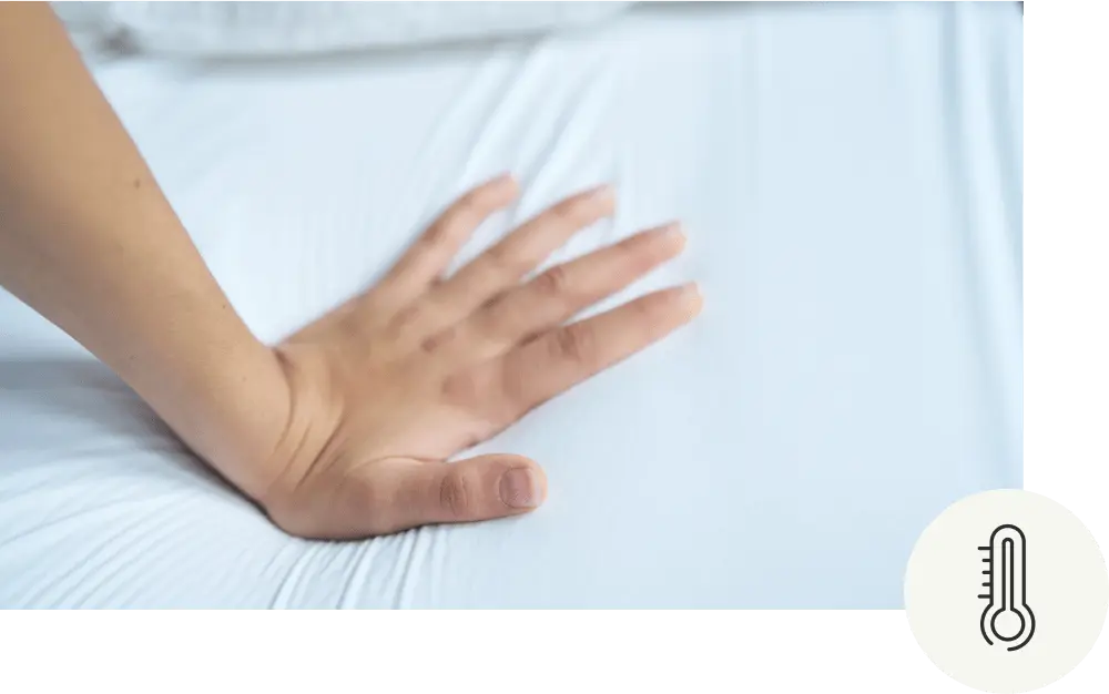 A hand pushing down on to a mattress