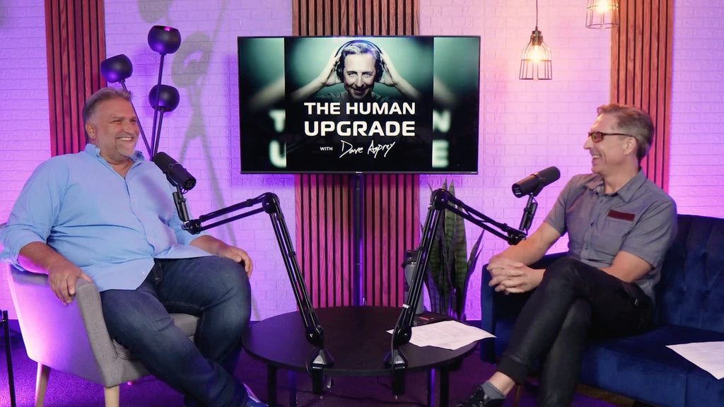 Jack Dell'Accio and Dave Asprey sitting and laughing while recording The Human Upgrade podcast in 2023