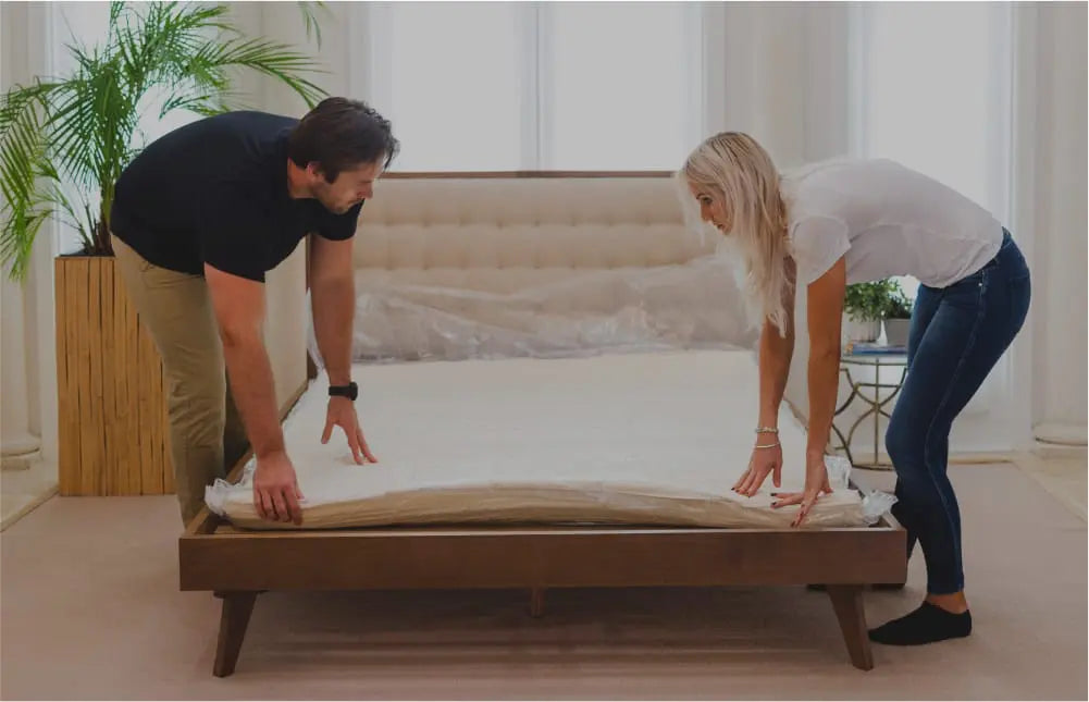 A couple rollin gout their newly delivered Essentia mattress.