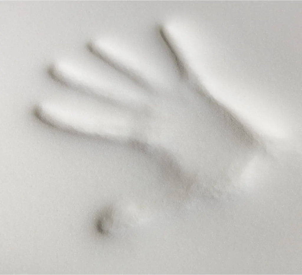A hand imprint in memory foam
