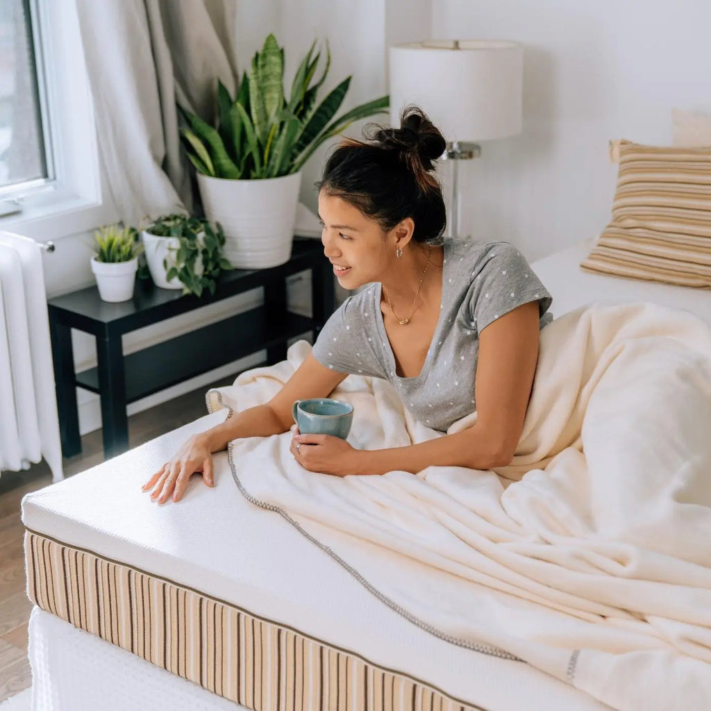 Girl laying down on an Essentia Classic REM5 organic mattress