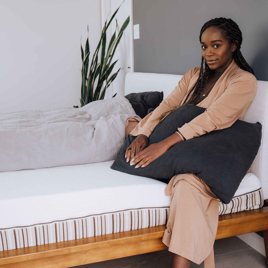 Aja Naomi King relaxing on her Essentia organic mattress 