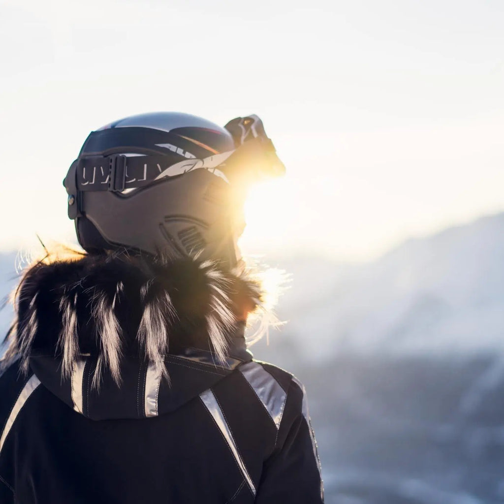Snowboarder enjoying the view at sunrise